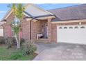 Inviting brick home with covered front porch, well-kept lawn, and attached two-car garage at 1232 Pressley Downs Se Dr, Concord, NC 28025