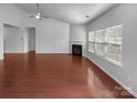 Spacious living room featuring hardwood floors, a fireplace, and plenty of natural light at 12332 Flatbush Dr, Huntersville, NC 28078
