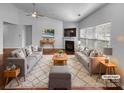Bright living room showcasing stylish furniture, hardwood floors, and a cozy fireplace at 12332 Flatbush Dr, Huntersville, NC 28078