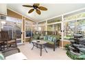 Bright sunroom with lots of windows, a ceiling fan, and comfortable seating, leading to an outdoor space at 12421 Poplar Forest Dr, Charlotte, NC 28278