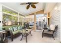 Bright sunroom with lots of windows, a ceiling fan, and comfortable seating, leading to an outdoor space at 12421 Poplar Forest Dr, Charlotte, NC 28278