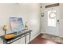 Inviting entryway featuring a decorative table and a glass-paneled front door at 12614 Chantrey Way, Huntersville, NC 28078
