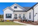 Charming exterior showing a covered porch with chairs and decorative planters near the main entry at 1323 Stack Rd, Monroe, NC 28112