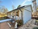 Exterior view of the home with light brick, wooden shutters, deck, and landscaped yard at 134 Weaver Hill Dr, Statesville, NC 28625