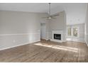 Bright living room boasts hardwood floors, a fireplace, and high ceilings at 13701 Dawlish Ln, Pineville, NC 28134
