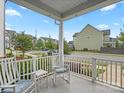 Inviting front porch with rocking chairs, cushions, and neighborhood views offers a relaxing outdoor space at 13923 Jacks Ln, Pineville, NC 28134