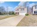 Two-story home with a well-maintained lawn and driveway leading to an attached garage at 203 Waterlemon Way, Monroe, NC 28110