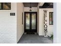 Close-up of the front entrance with double doors, overhead light, and welcome sign at 231 Sunny Path Ln, Statesville, NC 28677