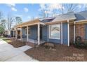Inviting townhome exterior showcasing a covered front porch, brick foundation, and well-maintained landscaping at 234 Pointe Cir, Rock Hill, SC 29732