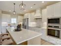 A modern, bright kitchen featuring stainless steel appliances and a large center island at 2355 Emanuel Church Rd, Rockwell, NC 28138