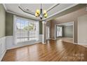 Bright dining room featuring hardwood floors, a large window, and elegant chandelier lighting at 252 Legend Dr, Rock Hill, SC 29732