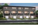 New townhomes feature private balconies, gray siding, and attached garages for convenient living at 305 Old Town Village Rd, Waxhaw, NC 28173