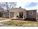 Single story home featuring a covered porch, an outdoor ceiling fan and chairs at 404 B And S Ln, Hickory, NC 28601