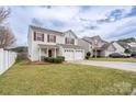 Charming two-story home with a well-maintained lawn, two-car garage, and an inviting front porch at 4213 Devonbridge Ln, Charlotte, NC 28269