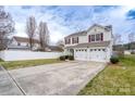 Charming two-story home features a two-car garage, red shutters, and a well-manicured front yard at 4213 Devonbridge Ln, Charlotte, NC 28269