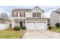 Charming two-story home with red shutters, a two-car garage, and a neatly landscaped front yard at 4213 Devonbridge Ln, Charlotte, NC 28269