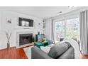 The open living room features a fireplace, mounted TV, and access to the patio at 525 N Graham St # 2F, Charlotte, NC 28202