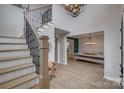 Spacious foyer featuring staircase with iron spindles and open access to the dining and living areas at 5431 Meadowcroft Way, Fort Mill, SC 29708