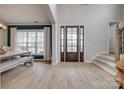 Bright foyer with soaring ceilings, beautiful wood-look floors and an elegant wood and glass front door at 5431 Meadowcroft Way, Fort Mill, SC 29708