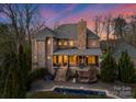 A brick two-story house with a covered porch, stone fireplace, and pool at 5824 Preston Ln, Charlotte, NC 28270