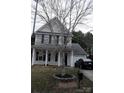 Lovely home with a manicured lawn, garage, and charming front porch enhanced by a picturesque tree in the front yard at 610 Trillium Sw Ct # 14, Conover, NC 28613