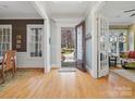 Bright and airy foyer with hardwood floors, detailed trim, and an open doorway with views to the front yard at 8416 Highgrove St, Charlotte, NC 28277
