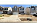 Charming two-story home featuring a two-car garage and a welcoming front porch at 9025 Remnick Dr, Gastonia, NC 28056
