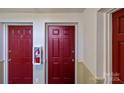 Hallway with red doors and a fire extinguisher at 9405 Old Concord Rd # G, Charlotte, NC 28213