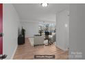 Bright, staged living room featuring wood-look floors, neutral paint, and large sliding glass doors to a balcony at 9405 Old Concord Rd # G, Charlotte, NC 28213