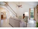 Bright living room featuring a staircase, neutral decor, and large windows for plenty of natural light at 10502 Orchid Hill Ln, Charlotte, NC 28277