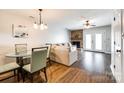 A comfortable seating area with a brick fireplace and lots of natural light flowing in through the nearby patio doors at 10961 Carmel Crossing Rd, Charlotte, NC 28226