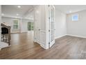 Bright and airy living area features hardwood floors, and glass doors leading to outdoor space at 1439 Hubert Graham Way, Tega Cay, SC 29708