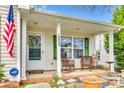 Inviting front porch with rocking chairs, green shutters, and a charming wreath on the front door at 1505 Andora Dr, Rock Hill, SC 29732