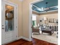 Elegant living room showcasing a decorative ceiling, stylish furniture, and bright natural light at 16205 Bastille Dr, Charlotte, NC 28278