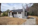 Charming home featuring a painted brick facade, black trim and a new roof at 244 Stilwell Oaks Cir, Charlotte, NC 28212