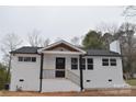 Charming brick ranch with a covered porch featuring black accents and a modern design at 244 Stilwell Oaks Cir, Charlotte, NC 28212