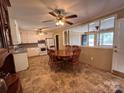 Eat-in kitchen features classic white cabinets and a view into the living room at 2458 Morningside Dr, Lancaster, SC 29720