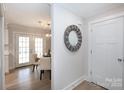 Hallway with decorative mirror leading to dining area with French doors at 3520 Colony Rd # E, Charlotte, NC 28211