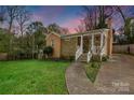 Beautiful single-story home with stone accents, a front porch, lush greenery and charming walkway at 4010 Hiddenbrook Dr, Charlotte, NC 28205