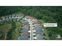 Aerial view of a residential neighborhood nestled among lush green trees and winding roads at 4922 Looking Glass Trl, Denver, NC 28037