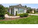 Beautiful single-story home featuring manicured landscaping and a curved sidewalk at 4922 Looking Glass Trl, Denver, NC 28037