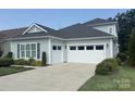 Spacious two-car garage with ample driveway and well-maintained landscaping at 4922 Looking Glass Trl, Denver, NC 28037