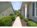 Inviting walkway leading to a charming home with lush landscaping at 4922 Looking Glass Trl, Denver, NC 28037