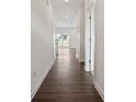 Hallway with wood flooring and white walls and doors at 557 Mountain View Dr, Monroe, NC 28110