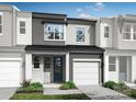 Modern townhome featuring neutral colors, a one-car garage, a covered front porch, and low-maintenance landscaping at 7008 Matz Way, Charlotte, NC 28269