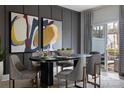Elegant dining room with modern art, stylish chairs, and sliding glass doors to a patio at 7012 Matz Way, Charlotte, NC 28269