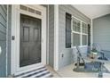 Inviting front porch with seating area, offering a warm welcome to visitors and residents alike at 7348 Adirondack Dr, Denver, NC 28037