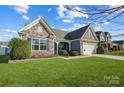 A well kept lawn and landscaping highlight this house's exterior at 7348 Adirondack Dr, Denver, NC 28037