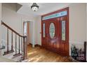 Elegant foyer featuring a hardwood floor and a beautifully crafted front door with glass accents at 7824 Hickory Stick Pl, Charlotte, NC 28277