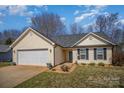 Inviting front of a house with a well-maintained lawn, two-car garage, and welcoming facade at 839 Prestwick Dr, Rock Hill, SC 29730